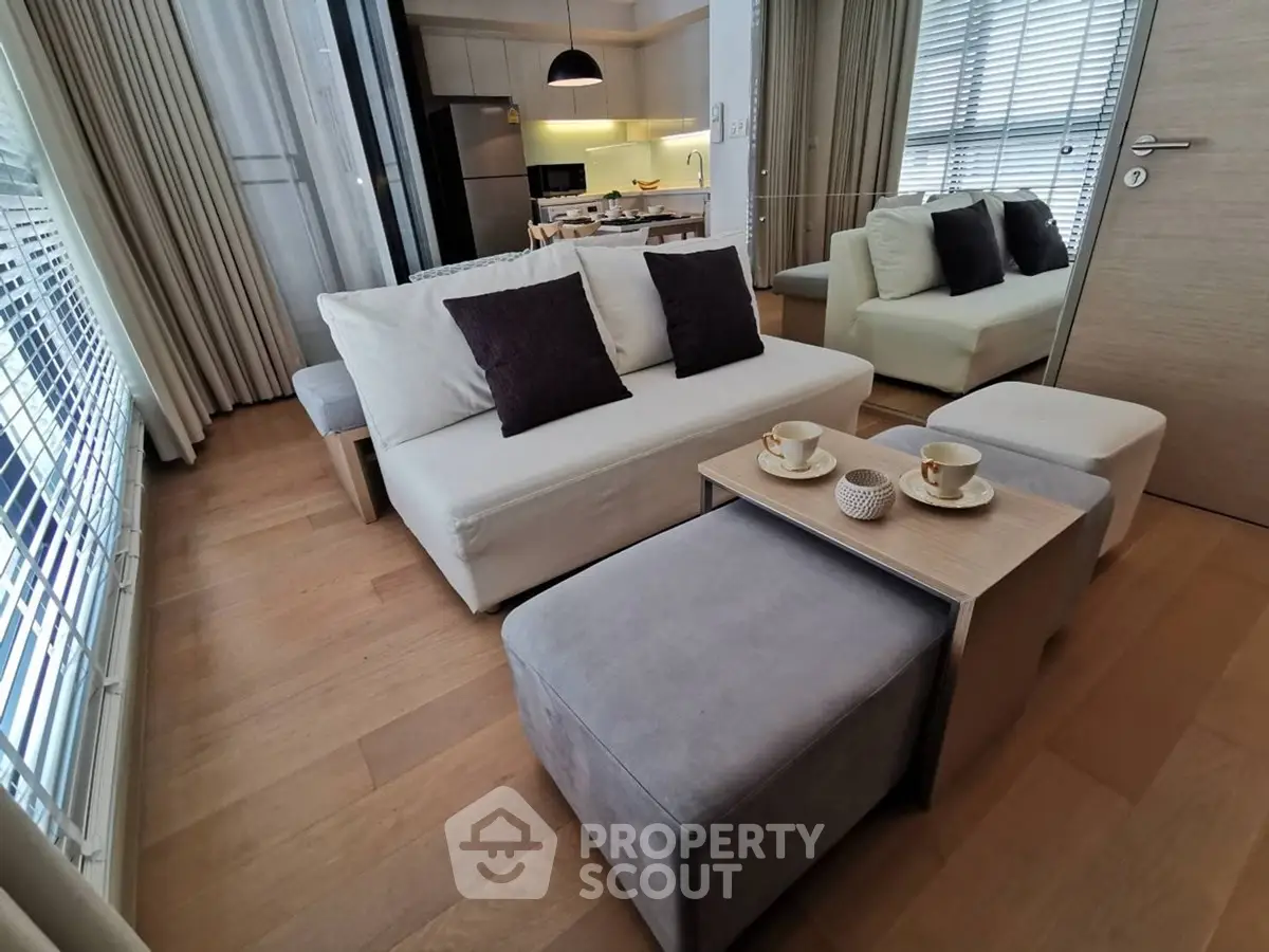 Modern living room with cozy seating and stylish decor in a contemporary apartment.