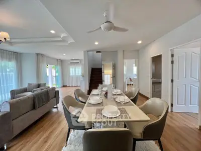 Spacious open-plan living and dining area with modern decor and natural light