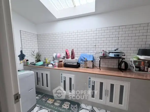 Charming kitchen with skylight and modern cabinetry, perfect for culinary enthusiasts.