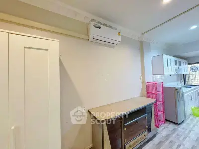 Modern kitchen with air conditioning and stylish cabinetry in a cozy apartment.