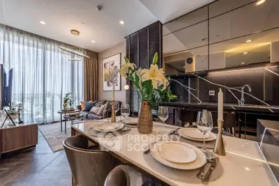 Luxurious open-plan living room and kitchen with elegant dining setup and modern decor.