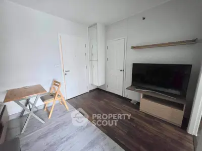 Modern living room with sleek TV setup and minimalist furniture design.
