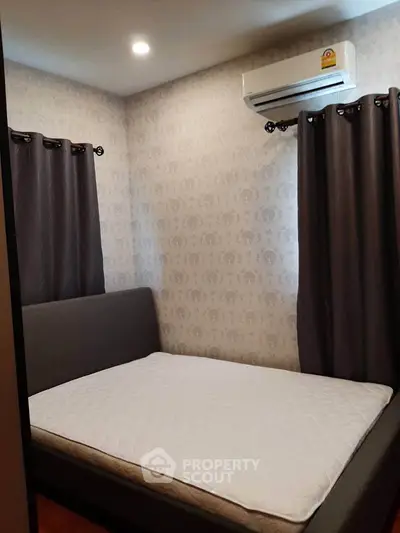Cozy bedroom with modern air conditioning and elegant curtains, perfect for restful nights.