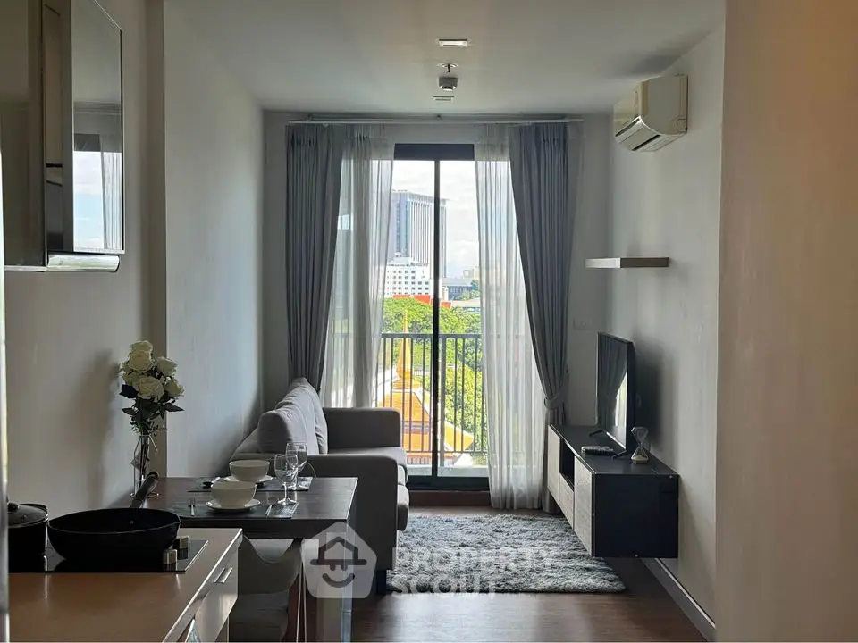 Modern living room with balcony view, sleek furniture, and natural light in urban apartment.
