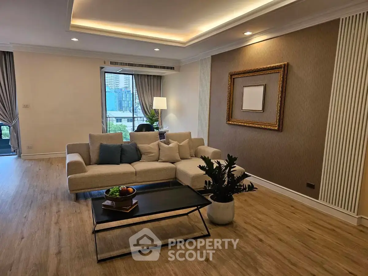Spacious modern living room with elegant decor and city view, featuring a cozy sofa and stylish coffee table.