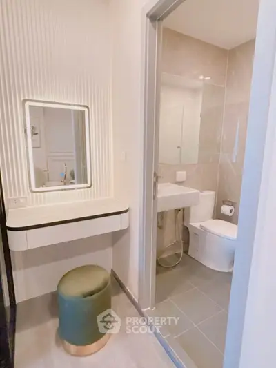 Modern bathroom with elegant vanity and mirror, featuring sleek design and contemporary fixtures.