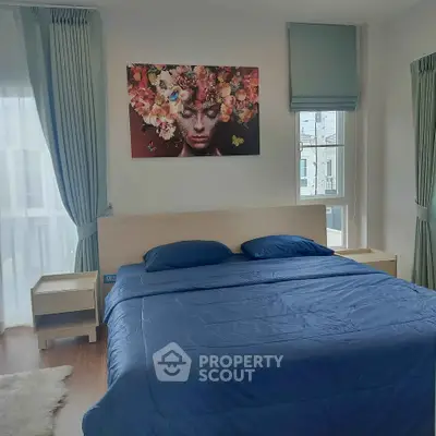 Modern bedroom with stylish decor and large windows offering natural light.