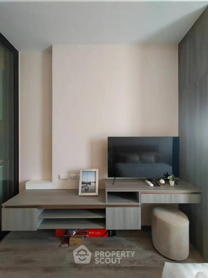 Modern living room with sleek TV unit and stylish decor in a contemporary apartment.