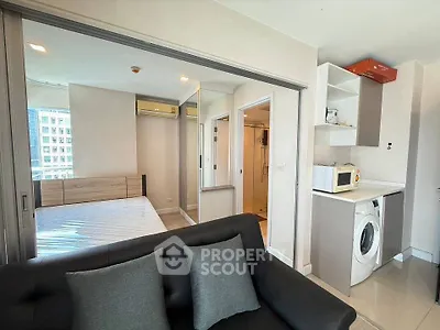 Modern studio apartment with sleek design, featuring a cozy living area, compact kitchen, and bright bedroom.