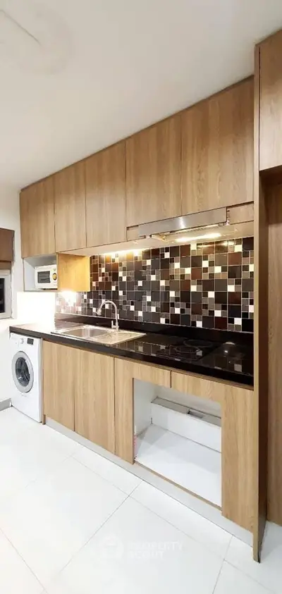 Modern kitchen with sleek wooden cabinets and stylish backsplash