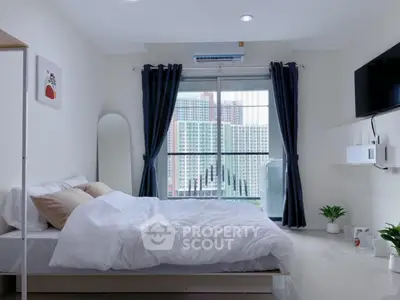 Modern bedroom with city view, featuring a cozy bed, wall-mounted TV, and large window with curtains.