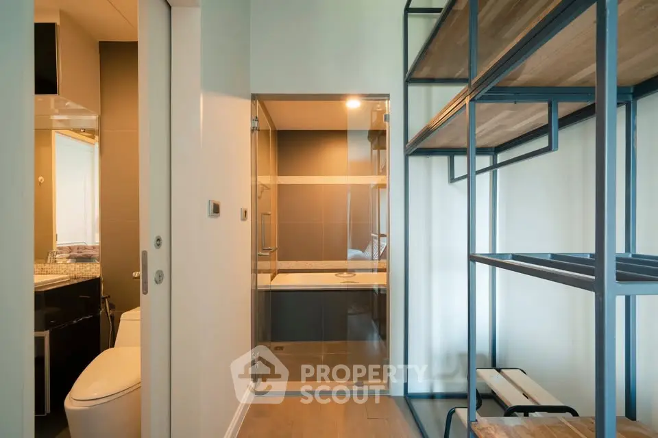 Modern bathroom with glass shower and sleek shelving unit