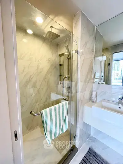Modern bathroom with glass shower and sleek fixtures
