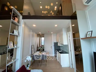 Modern open-plan living and dining area with high ceilings and stylish decor.