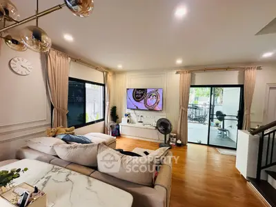 Spacious modern living room with elegant decor and large windows, perfect for relaxation and entertainment.