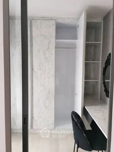 Elegant modern study area with built-in wardrobe and sleek black chair