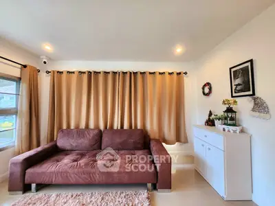 Cozy living room with brown sofa and elegant decor, perfect for relaxation.