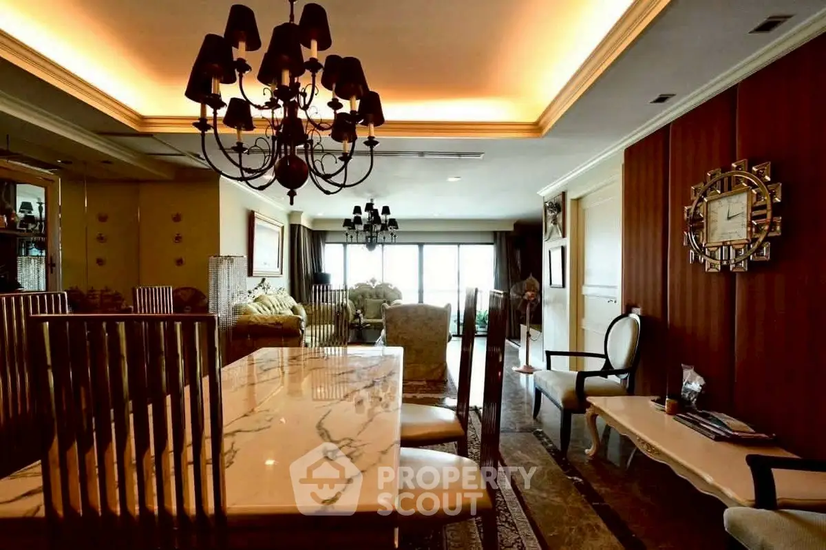 Luxurious dining room with elegant chandelier and marble table in upscale apartment