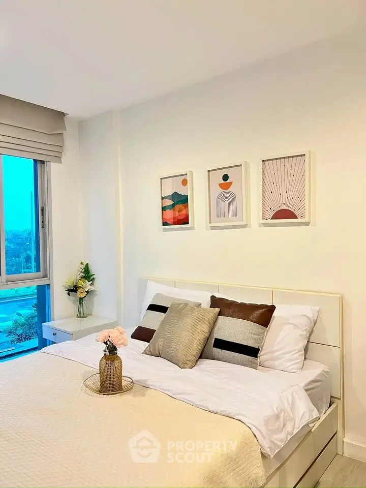 Cozy bedroom with modern decor and large window offering scenic views.