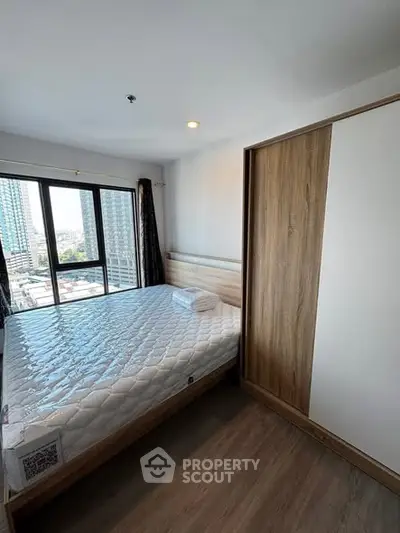 Modern bedroom with city view and wooden wardrobe