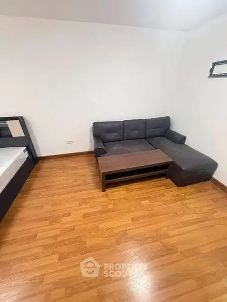 Cozy living room with wooden flooring and modern furniture in a minimalist design.