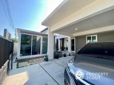 Modern single-story home with spacious driveway and sleek carport