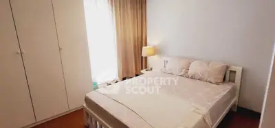 Cozy bedroom with natural light and stylish decor in modern apartment.