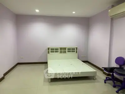 Minimalist bedroom with modern bed frame and purple accents