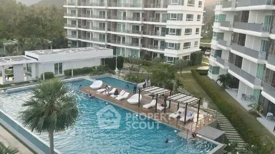 Luxurious condominium complex with a stunning outdoor pool and modern architecture.