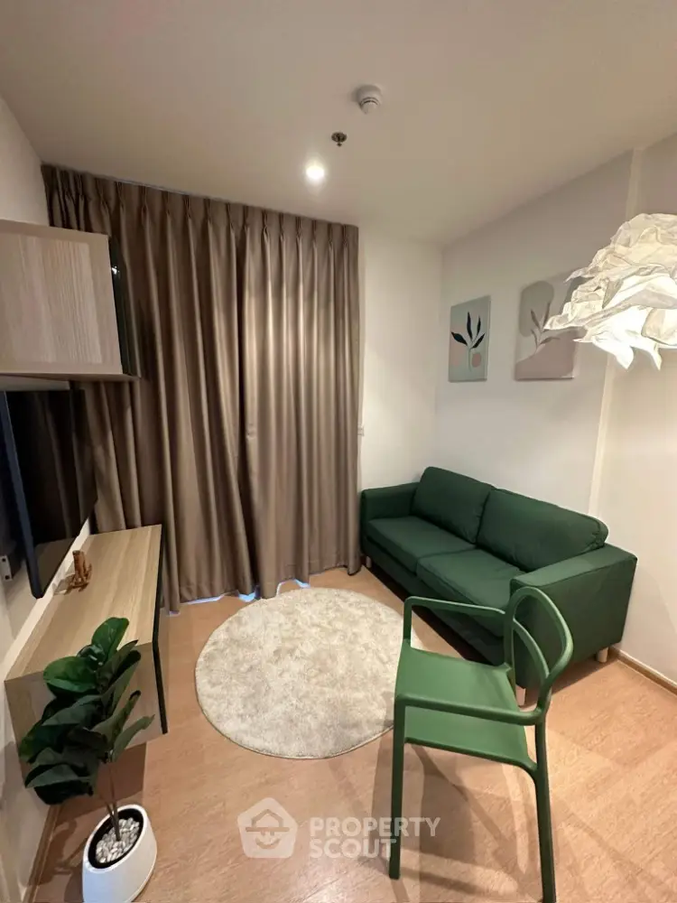 Modern living room with green sofa and stylish decor in cozy apartment