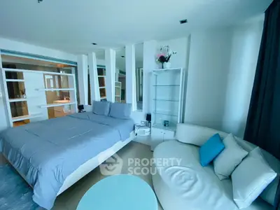 Modern bedroom with stylish decor and cozy seating area