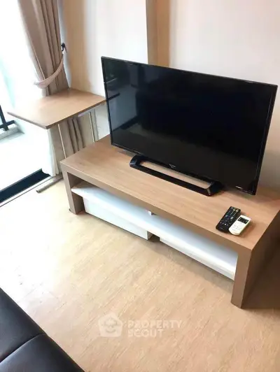 Modern living room with sleek TV setup and natural light