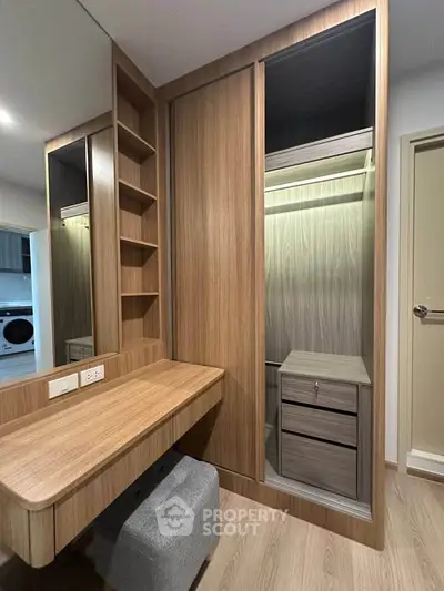 Modern bedroom with built-in wooden wardrobe and stylish vanity desk