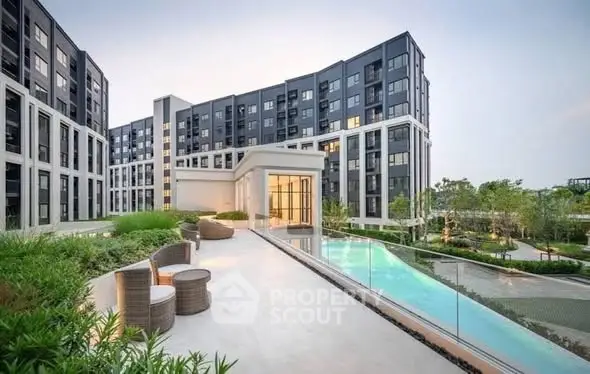 Luxurious modern apartment complex with pool and lush gardens, perfect for upscale living.