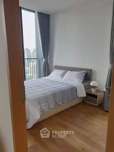 Modern bedroom with city view and stylish decor in high-rise apartment