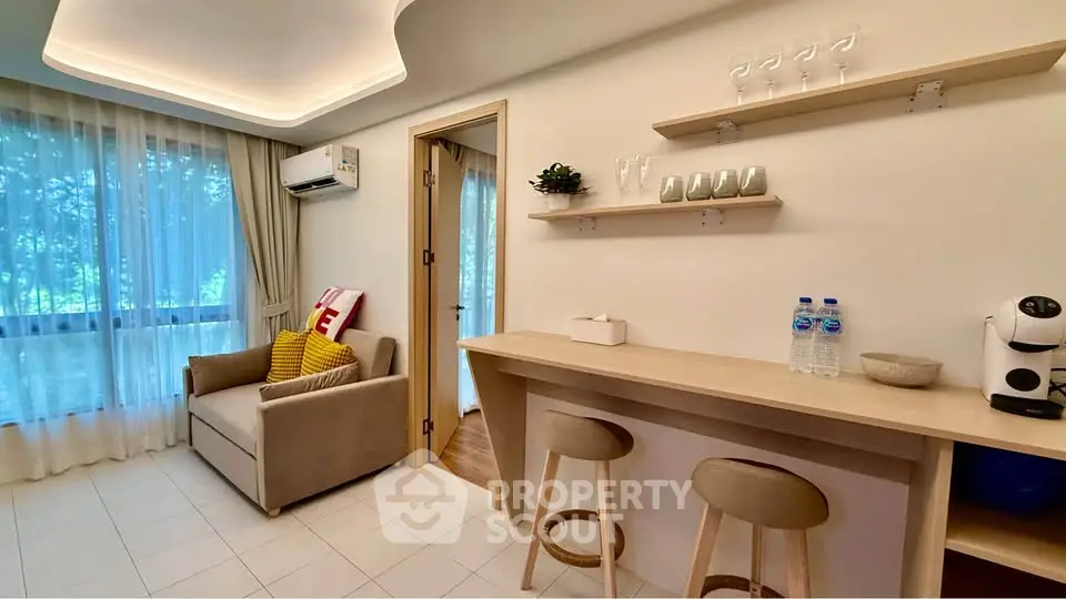 Modern living room with cozy seating and stylish bar area, featuring natural light and elegant decor.