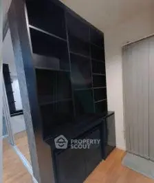 Modern storage unit with sleek black shelves in a contemporary interior space.