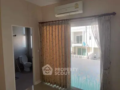Cozy bedroom with air conditioning and balcony access, featuring a private bathroom for ultimate convenience.