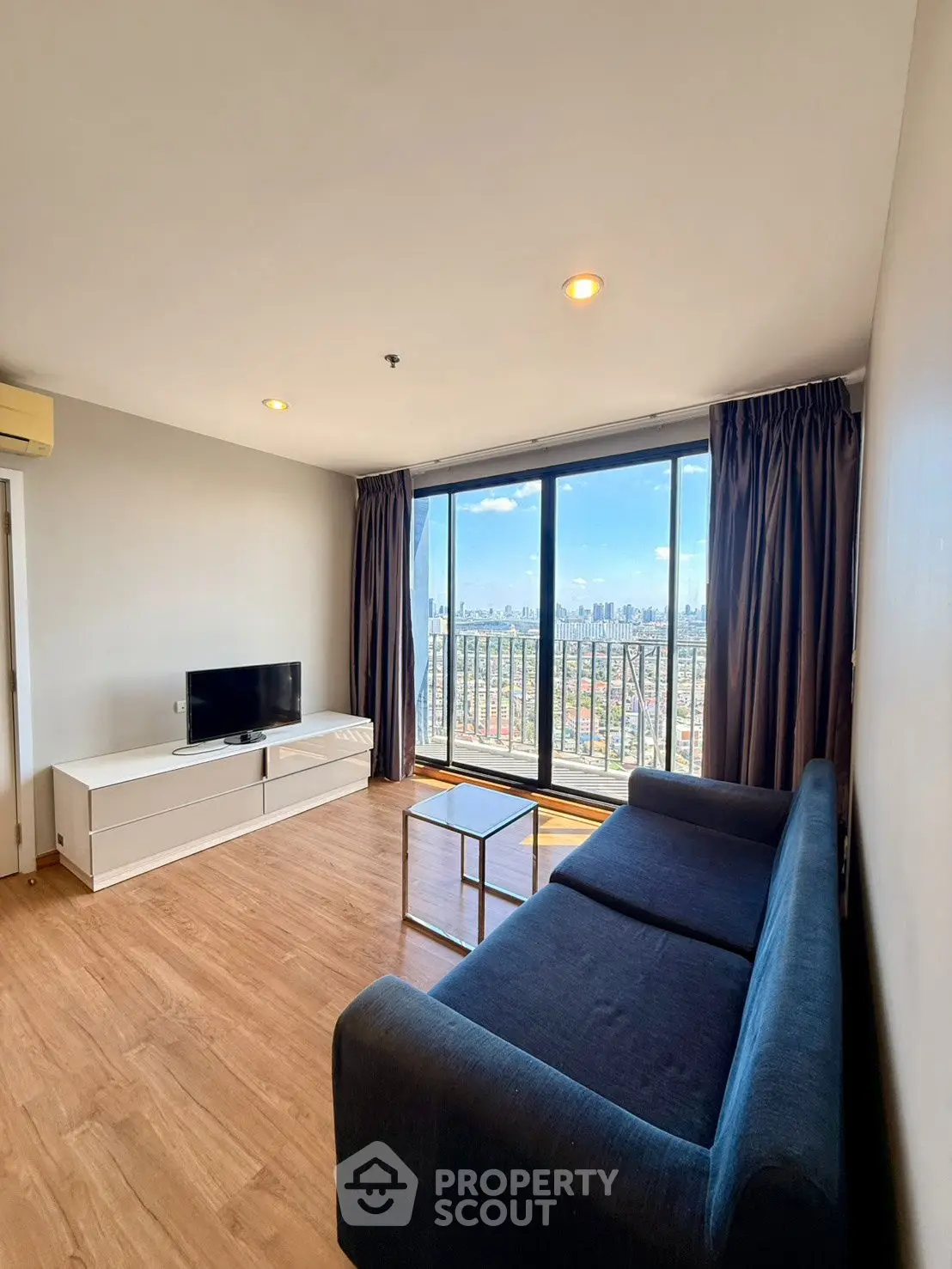 Modern living room with stunning city view and sleek furnishings