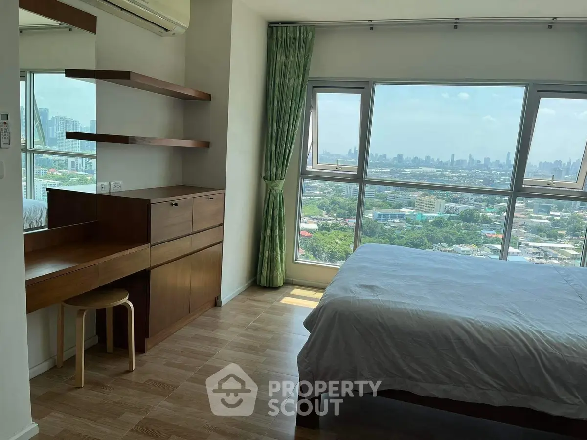 Spacious bedroom with stunning city view and modern wooden furniture