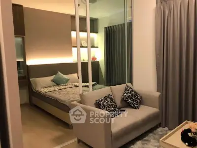 Modern bedroom with cozy sofa and stylish decor in a chic apartment.