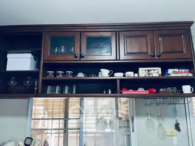 Charming kitchen with wooden cabinets and glassware display