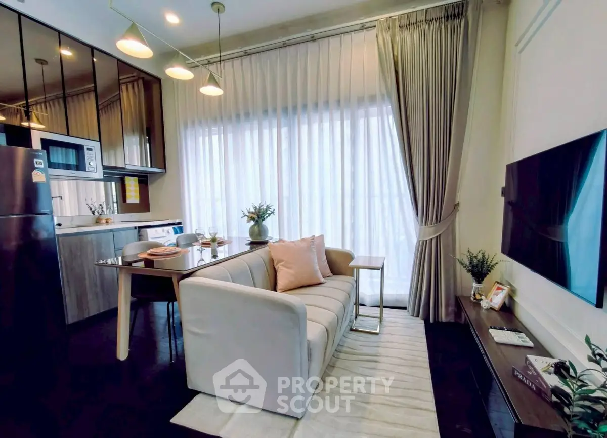 Modern living room with elegant decor and open kitchen layout in a stylish apartment.