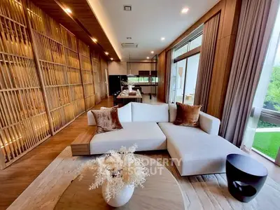 Luxurious modern living room with elegant wooden accents and large windows offering a serene garden view.