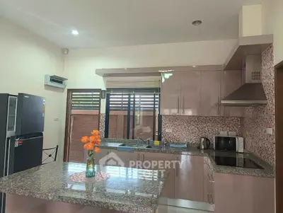 Modern kitchen with granite countertops and sleek appliances in a stylish home.