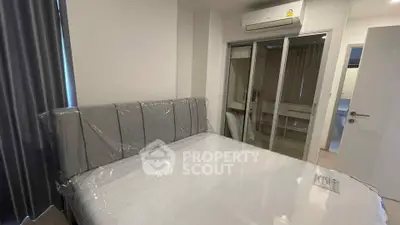 Modern bedroom with air conditioning and mirrored closet doors in a stylish apartment.