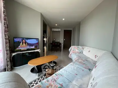 Spacious living room with modern decor and cozy sectional sofa, perfect for relaxation and entertainment.