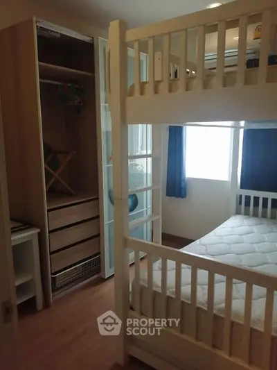 Cozy bedroom with bunk bed and built-in wardrobe, perfect for maximizing space in a modern home.