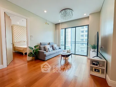 Spacious living room with modern decor and balcony view in luxury apartment