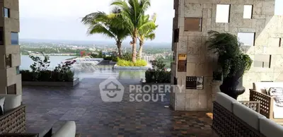 Luxurious outdoor pool area with stunning view and palm trees, perfect for relaxation and entertainment.